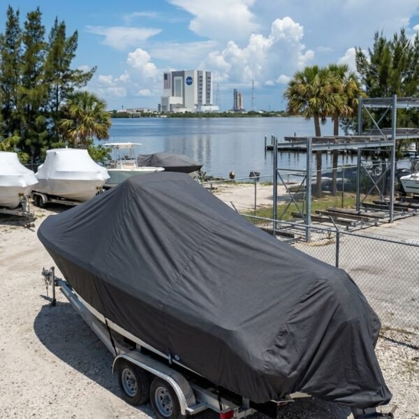 EdgeWater 188 CC boat cover in charcoal Sunbrella fabric on trailer at Titusville Florida marina near Kennedy Space Center