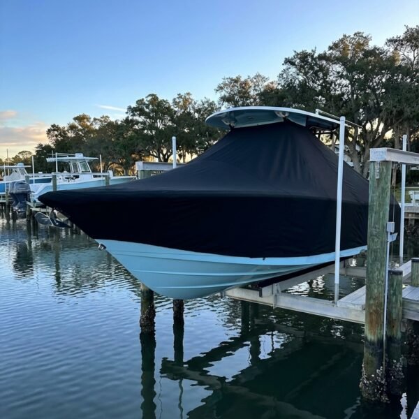 EdgeWater 205 T-Top boat cover in black Sunbrella fabric on dock lift at New Smyrna Beach Florida marina