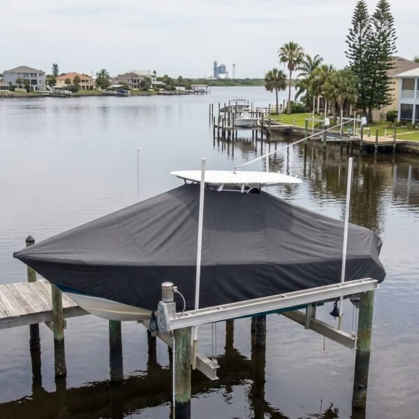 EdgeWater 230 T-Top boat cover in charcoal Sunbrella fabric on dock lift at Cape Canaveral Florida