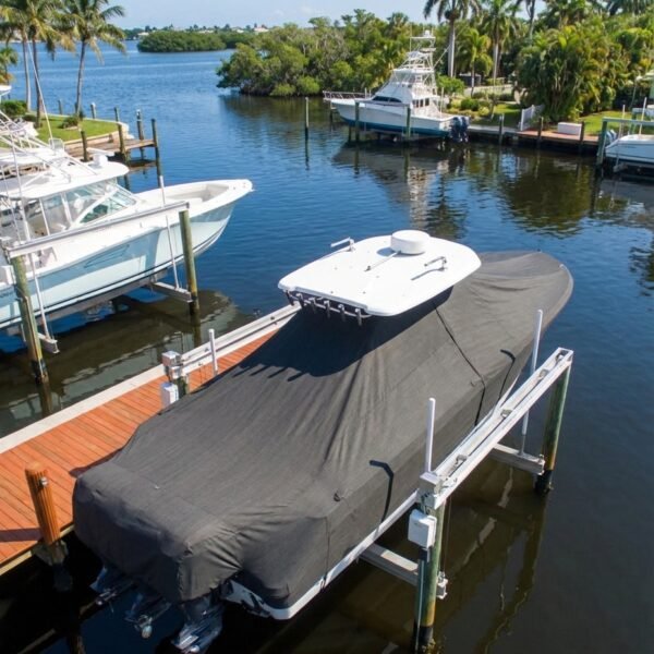 EdgeWater 340 T-Top boat cover in charcoal Sunbrella fabric on dock lift at Stuart Florida marina
