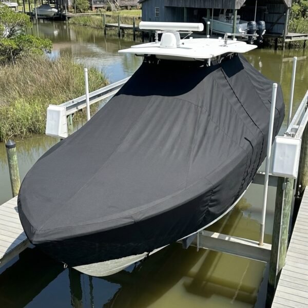 NauticStar 2102 Legacy T-Top boat cover in Black Sunbrella fabric on dock lift at Ocean Springs, MS