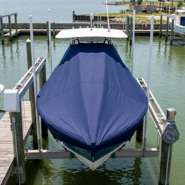 NauticStar 227 XTS T-Top boat cover in Navy Sunbrella fabric on dock lift at Mobile Bay, AL