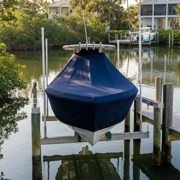 NauticStar 2302 T-Top boat cover in Navy Sunbrella fabric on dock lift at Perdido Key, FL