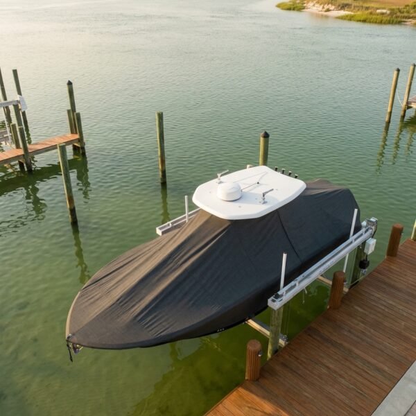NauticStar 249 XTS T-Top boat cover in Charcoal Sunbrella fabric on GIWW dock lift at Dauphin Island, AL