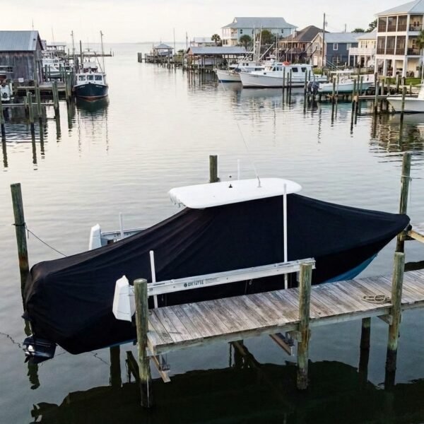 NauticStar 2500 T-Top boat cover in Black Sunbrella fabric on canal lift at Pass Christian, MS
