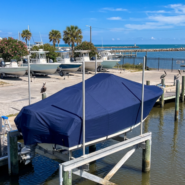 Sailfish 188 CC center console boat cover in navy Sunbrella fabric on boat rack at Port Aransas Texas