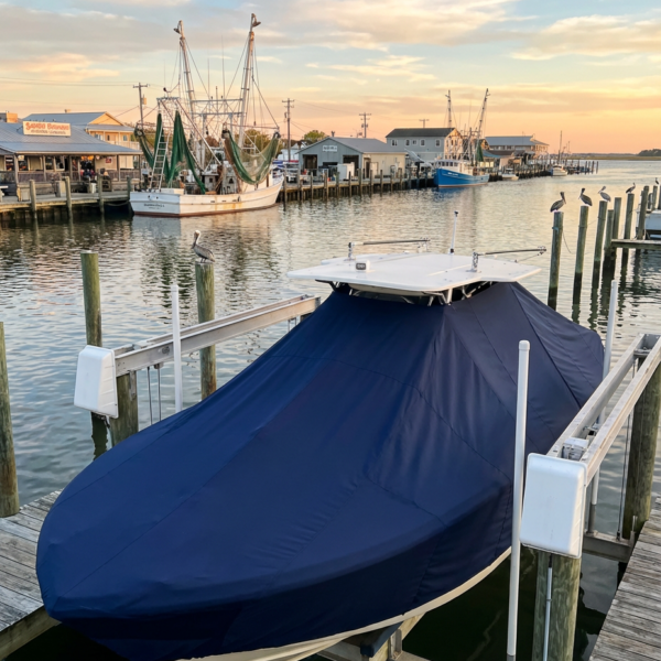 Scout 205 SP T-Top boat cover in navy Sunbrella fabric on dock lift at Morehead City North Carolina