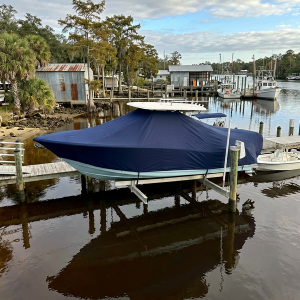 Scout 215 XSF T-Top boat cover in navy Sunbrella fabric on dock lift at Steinhatchee Florida
