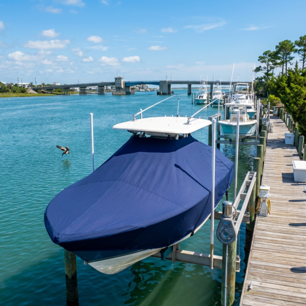 Scout 280 Sportfish T-Top boat cover in navy Sunbrella fabric on dock lift at Wrightsville Beach North Carolina