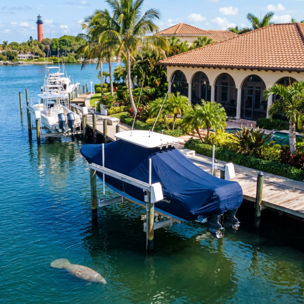 Scout 305 LXF T-Top boat cover in navy Sunbrella fabric on canal lift at Jupiter Florida