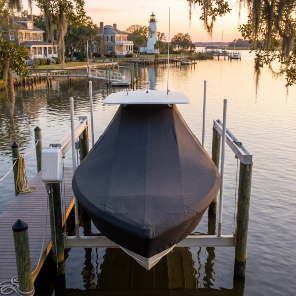 Sea Pro 27 T-Top boat cover in Charcoal Sunbrella fabric on dock lift at Southport, NC