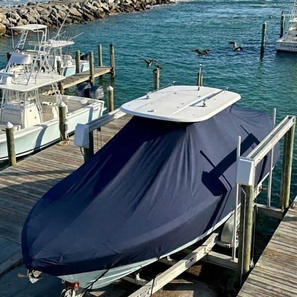 Blackfin 272 T-Top boat cover in Navy Sunbrella fabric on dock lift at Sebastian Inlet, FL
