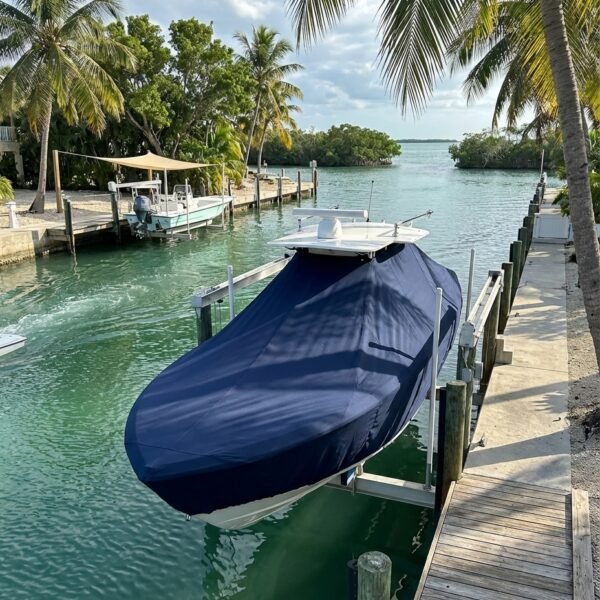 Contender 21 T-Top boat cover in Navy Sunbrella fabric on dock lift at Key Largo, Florida