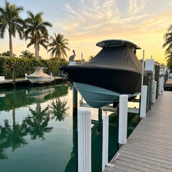 Intrepid 23 T-Top boat cover in Charcoal Sunbrella fabric on dock lift at Dania Beach, Florida
