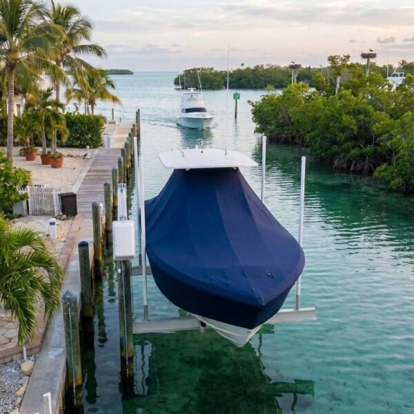 Pathfinder 2000 V T-Top boat cover in Navy Sunbrella fabric on dock lift at Vero Beach, Florida