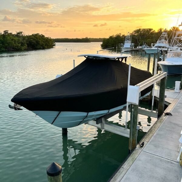 Pursuit 288 S T-Top boat cover in Black Sunbrella fabric on dock lift at Jupiter Inlet, Florida