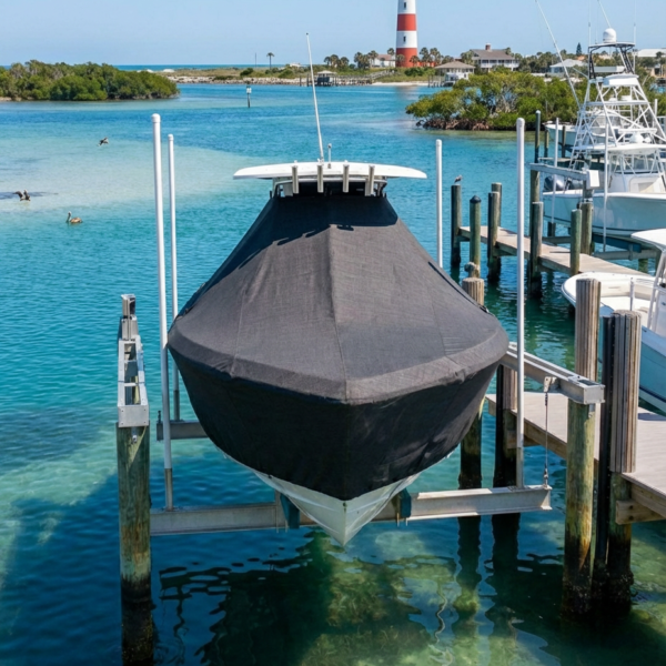 Pursuit 3480 T-Top boat cover in Charcoal Sunbrella fabric on dock lift at Ponce Inlet, Florida