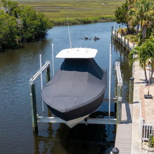 Sea Fox 216 T-Top boat cover in Charcoal Sunbrella fabric on dock lift at Fripp Island Marina, Fripp Island, SC
