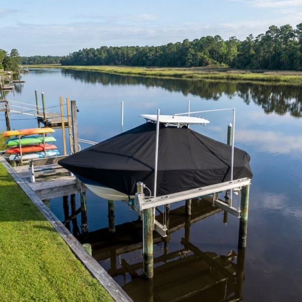 Sea Fox 220 XT T-Top boat cover in Black Sunbrella fabric on dock lift at Litchfield Creek, Litchfield Beach, SC