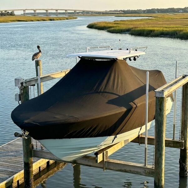 Sea Fox 237 T-Top boat cover in Black Sunbrella fabric on dock lift at Folly Beach Marina, Folly Beach, SC
