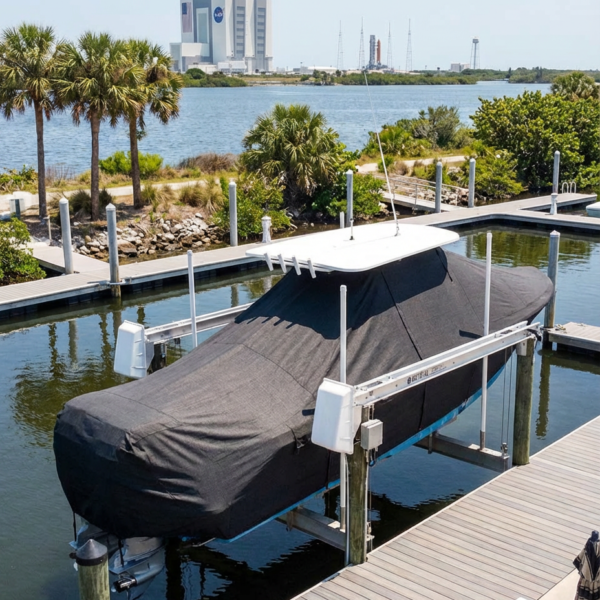 Sea Fox 268 Traveler T-Top boat cover in Charcoal Sunbrella fabric on canal lift at Cape Marina, Cape Canaveral, FL