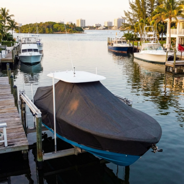 Sea Fox 368 Commander T-Top boat cover in Charcoal Sunbrella fabric on canal lift at Riviera Beach Marina, Riviera Beach, FL