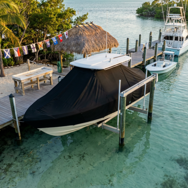 Sea Vee 322 Z T-Top boat cover in black Sunbrella fabric on dock lift at Islamorada, Florida Keys