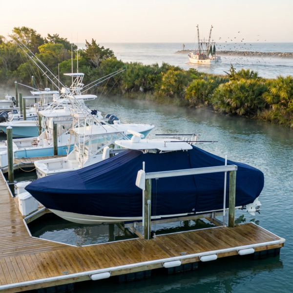 Tidewater 198 T-Top boat cover in Navy Sunbrella fabric on dock lift at Murrells Inlet, South Carolina