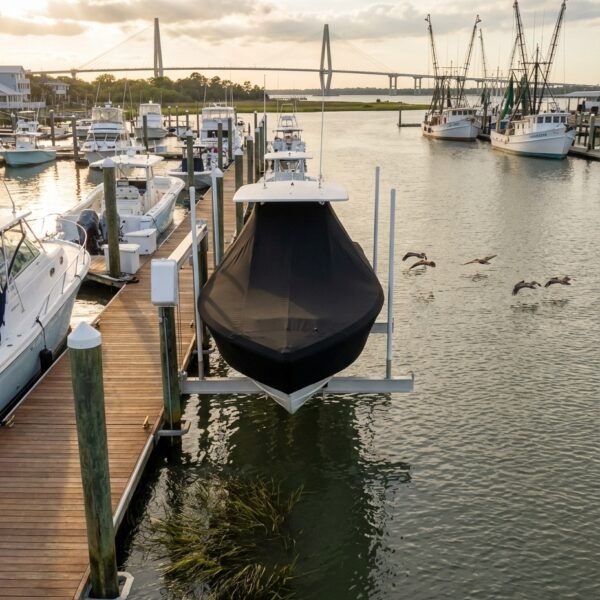 Tidewater 2000 T-Top boat cover in Black Sunbrella fabric on dock lift at Charleston, South Carolina