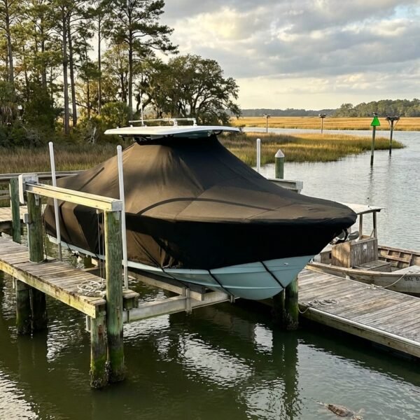 Tidewater 2300 Carolina Bay T-Top boat cover in Black Sunbrella fabric on dock lift