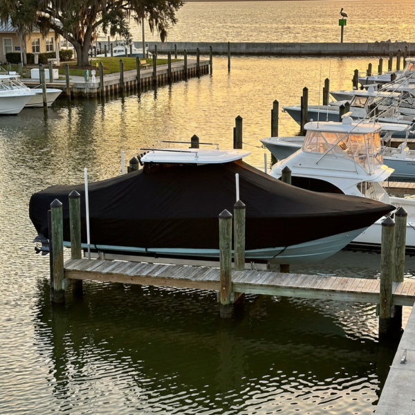 Yellowfin 39 T-Top boat cover in Black Sunbrella fabric on dock lift at Punta Gorda, Florida